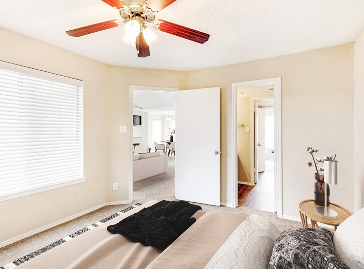 Bedroom with Ceiling Fan and door leading to living room