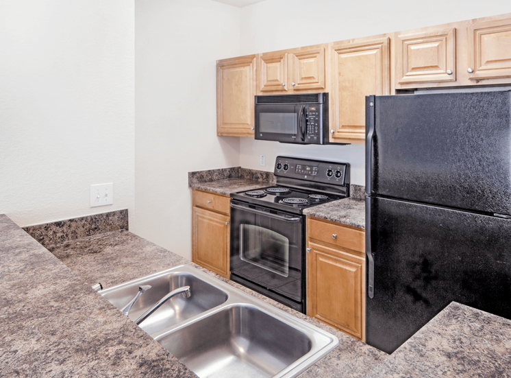 Fully equipped kitchen with black appliances