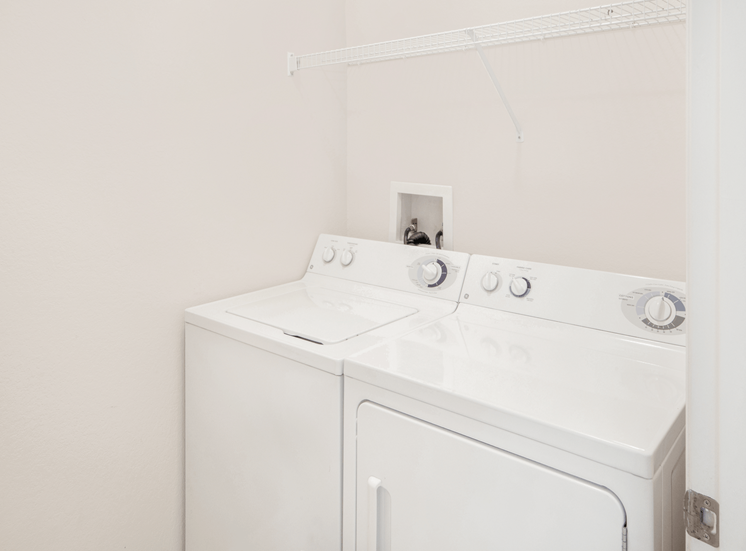 Full sized washer and dryer connections with storage wrack, and hardwood style flooring
