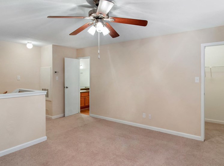 Living room with ceiling fan and wall to wall carpet