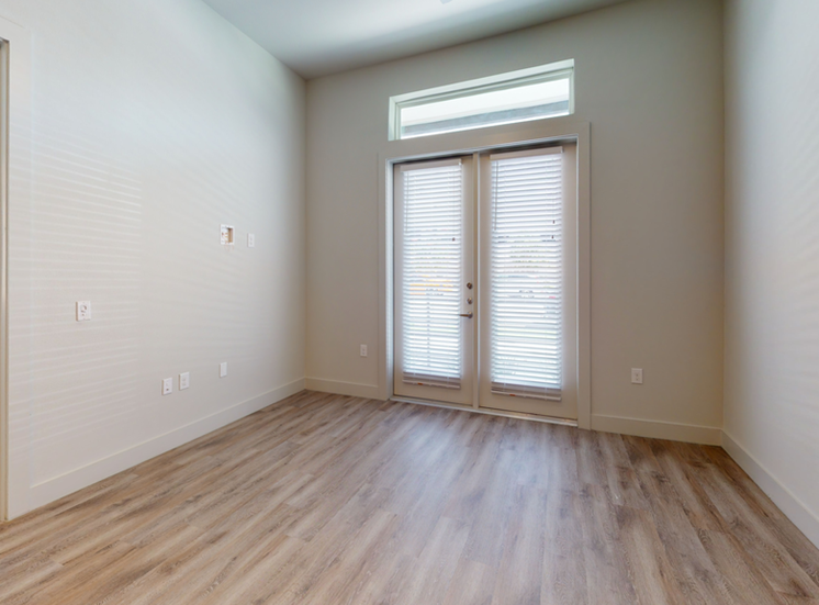 Livingroom with wood style flooring and door with blinds