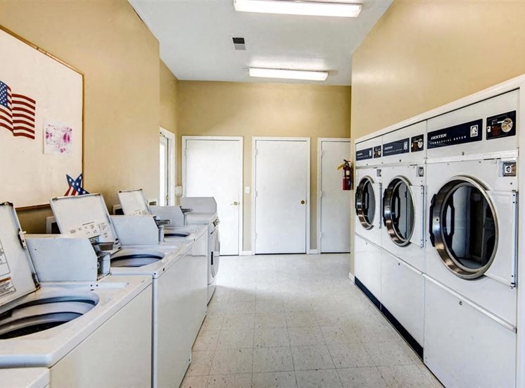 Laundry Facilities with Washers and Dryers and Bulletin Board on the Wall
