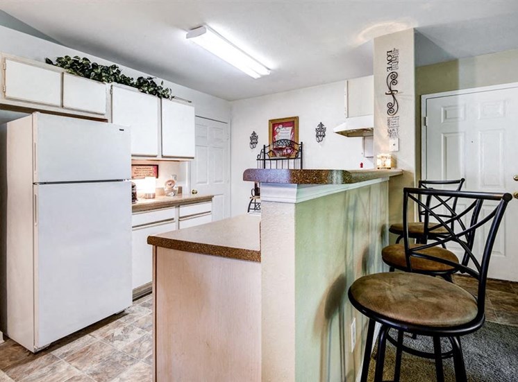 Model Kitchen ith White Cabinets and Appliances and Breakfast Bar and Bar Stools