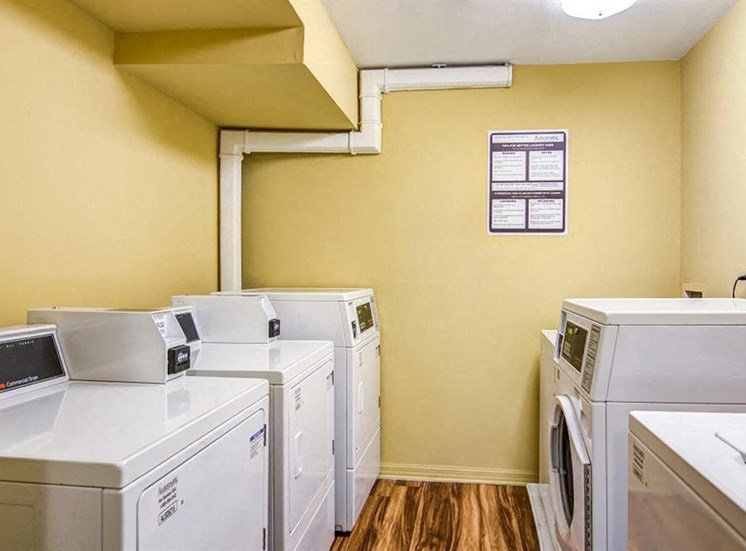 Yellow Laundry Facility with Washer and Dryers