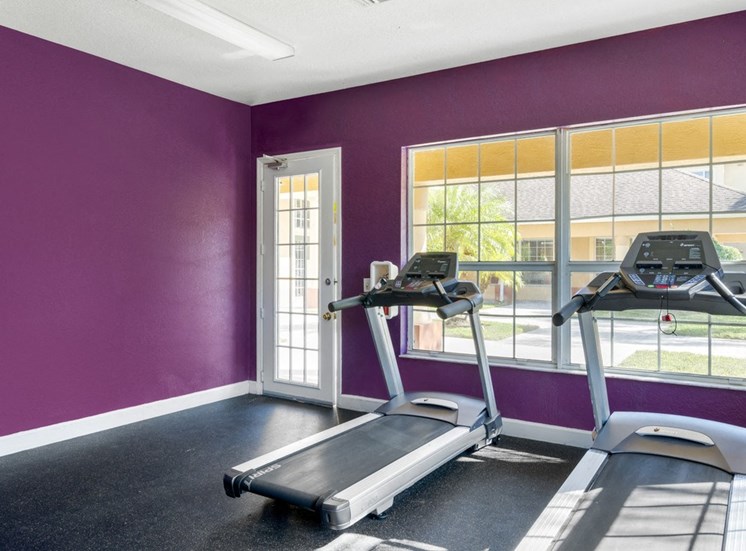 Fitness Center with Purple Walls, Exercise Equipment  and Windows
