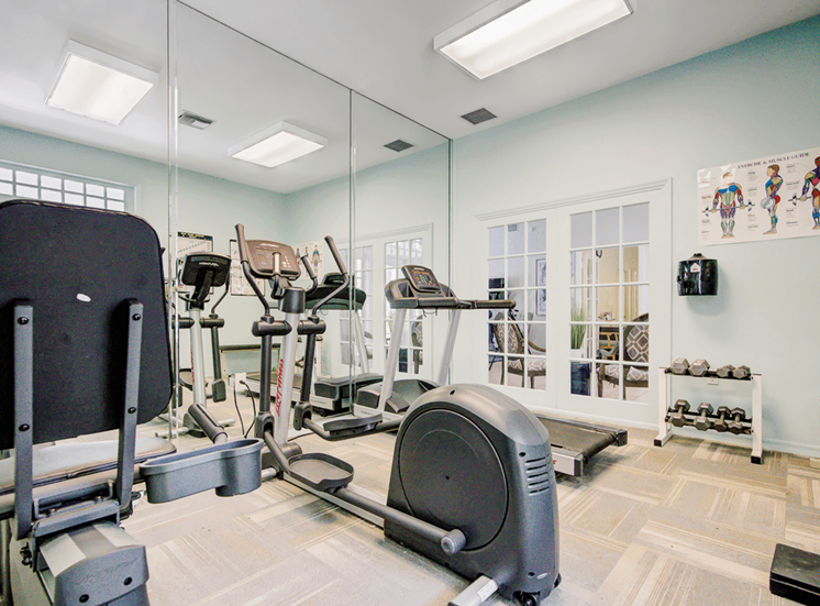 Fitness center with cardio equipment, dumb bell free eights and large mirror wall