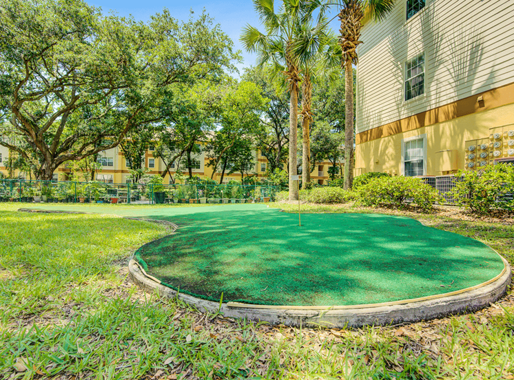 Artificial putting green overlooking the community garden and surrounded by native landscape