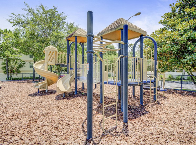 Blue and beige playground area with slides and several climbing areas.