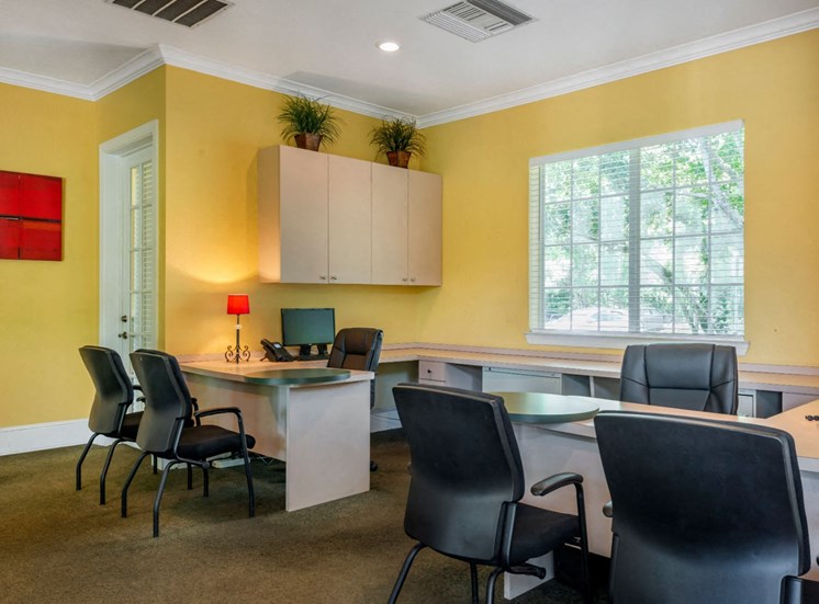 Yellow Leasing Office with Large Window Tan Cabinets and Counters with Black Chairs