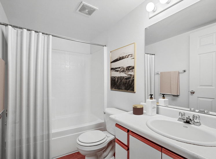 Virtually staged bathroom with shower curtain, wall art, white sink and countertop and shower