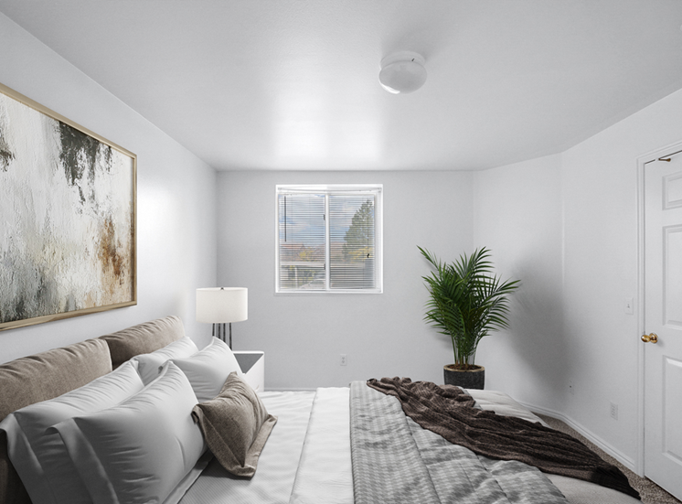 Virtually staged bedroom with bed, wall art, side table with lamp, potted plant, carpet and white walls and window