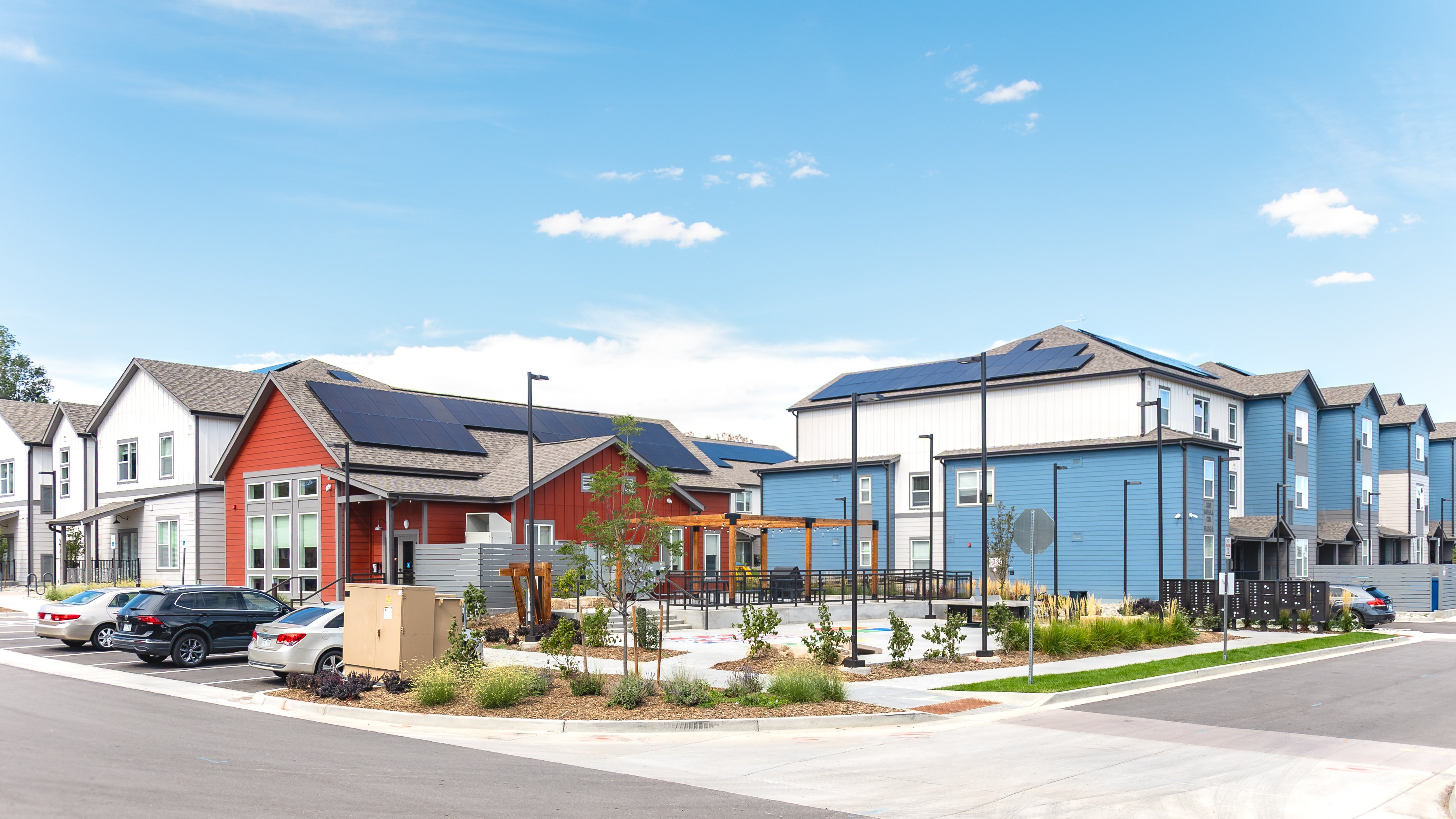 A row of houses with solar panels on the roofs.