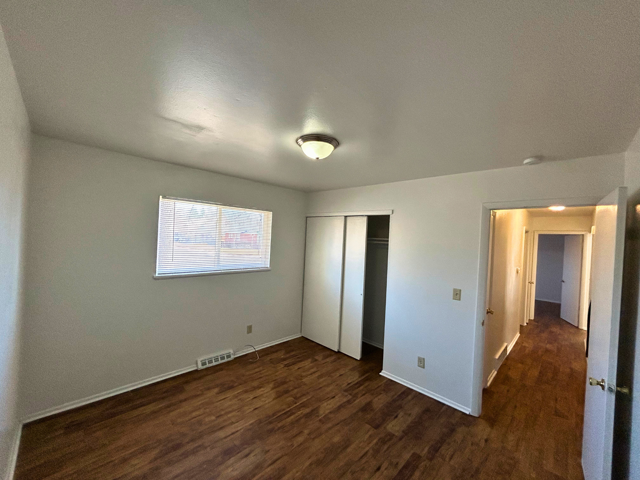 A room with wooden floors and white walls.