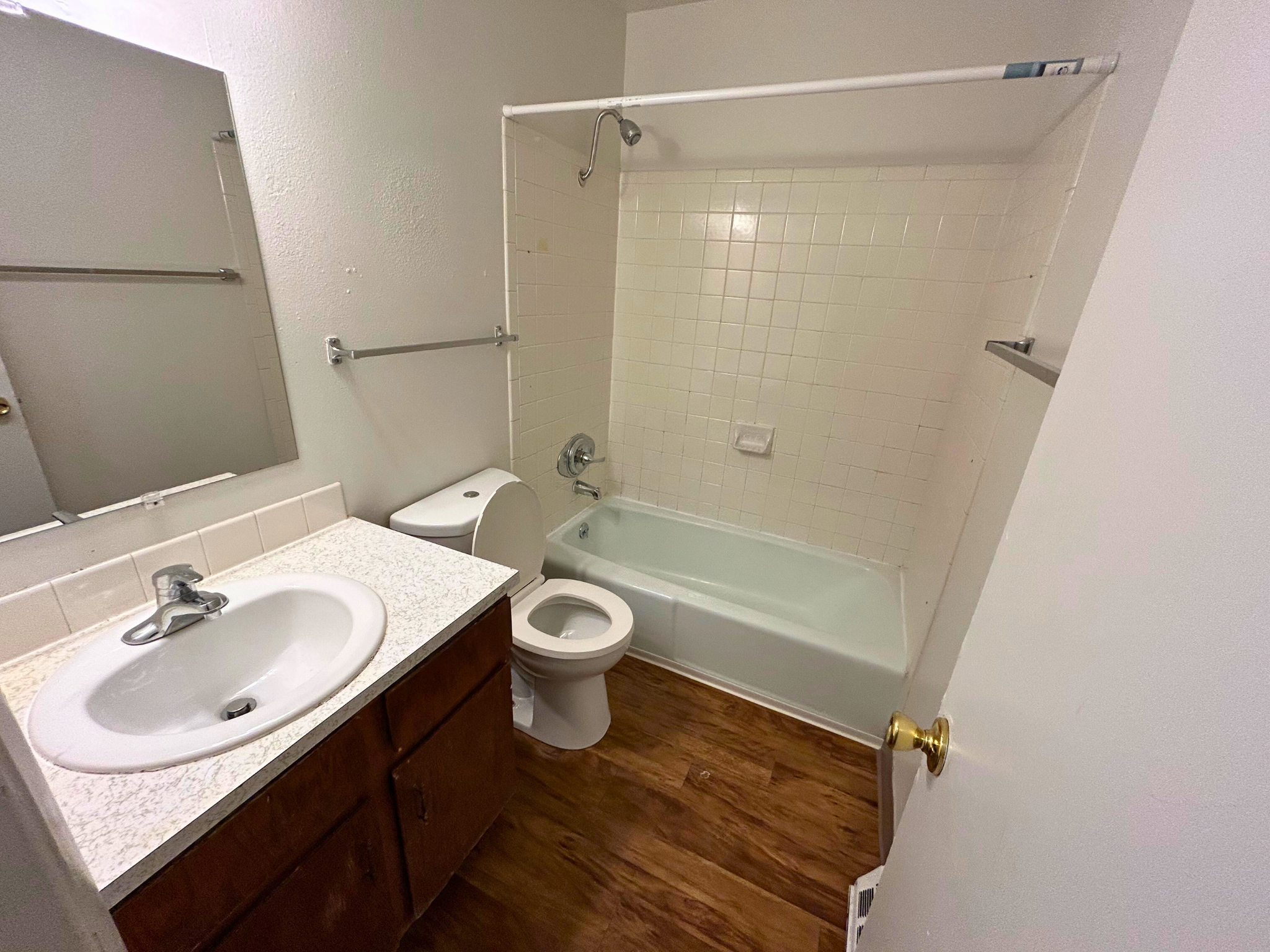 A white bathroom with a toilet, sink, and bathtub.