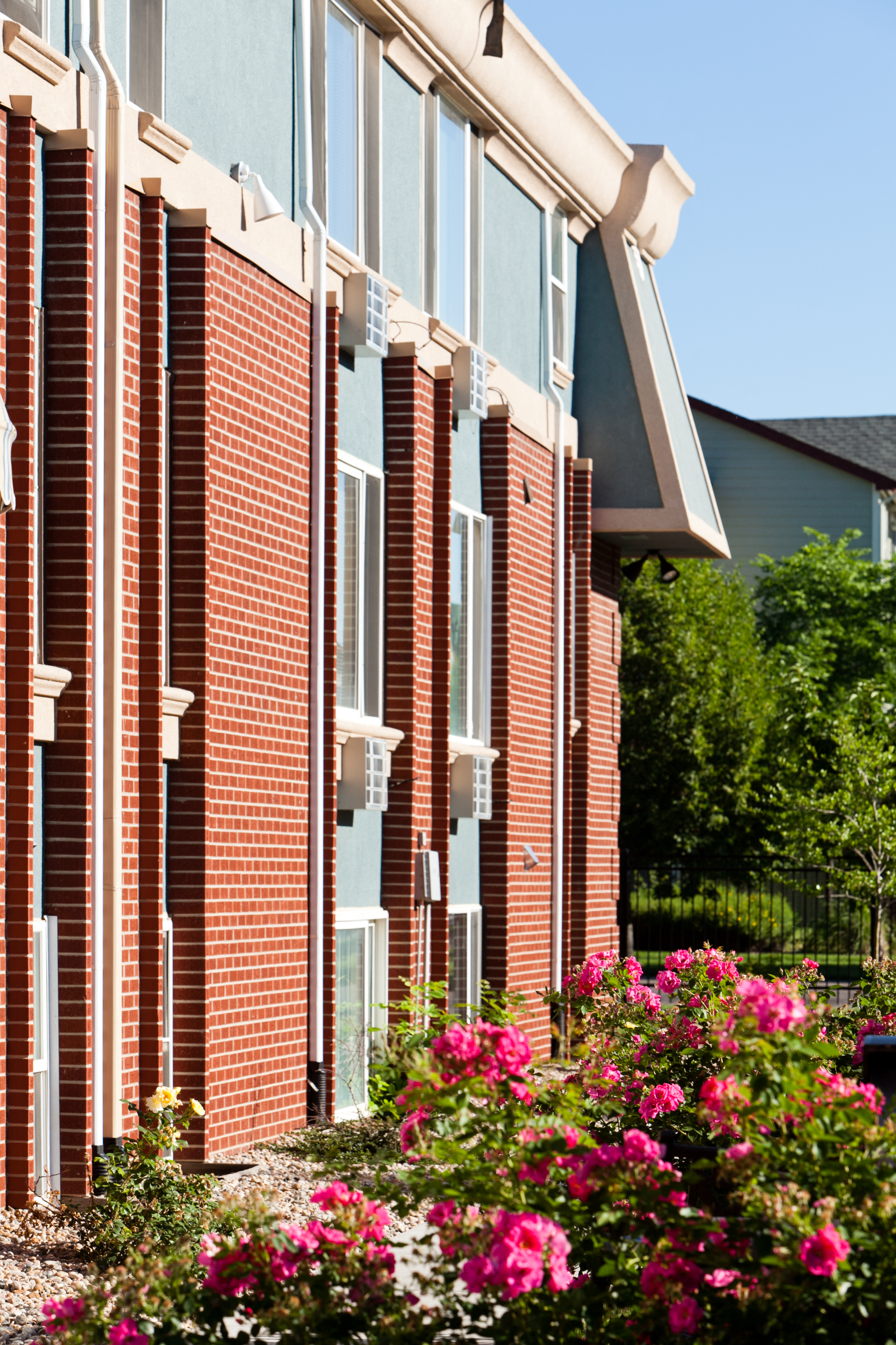 A red brick building with a white trim and windows.