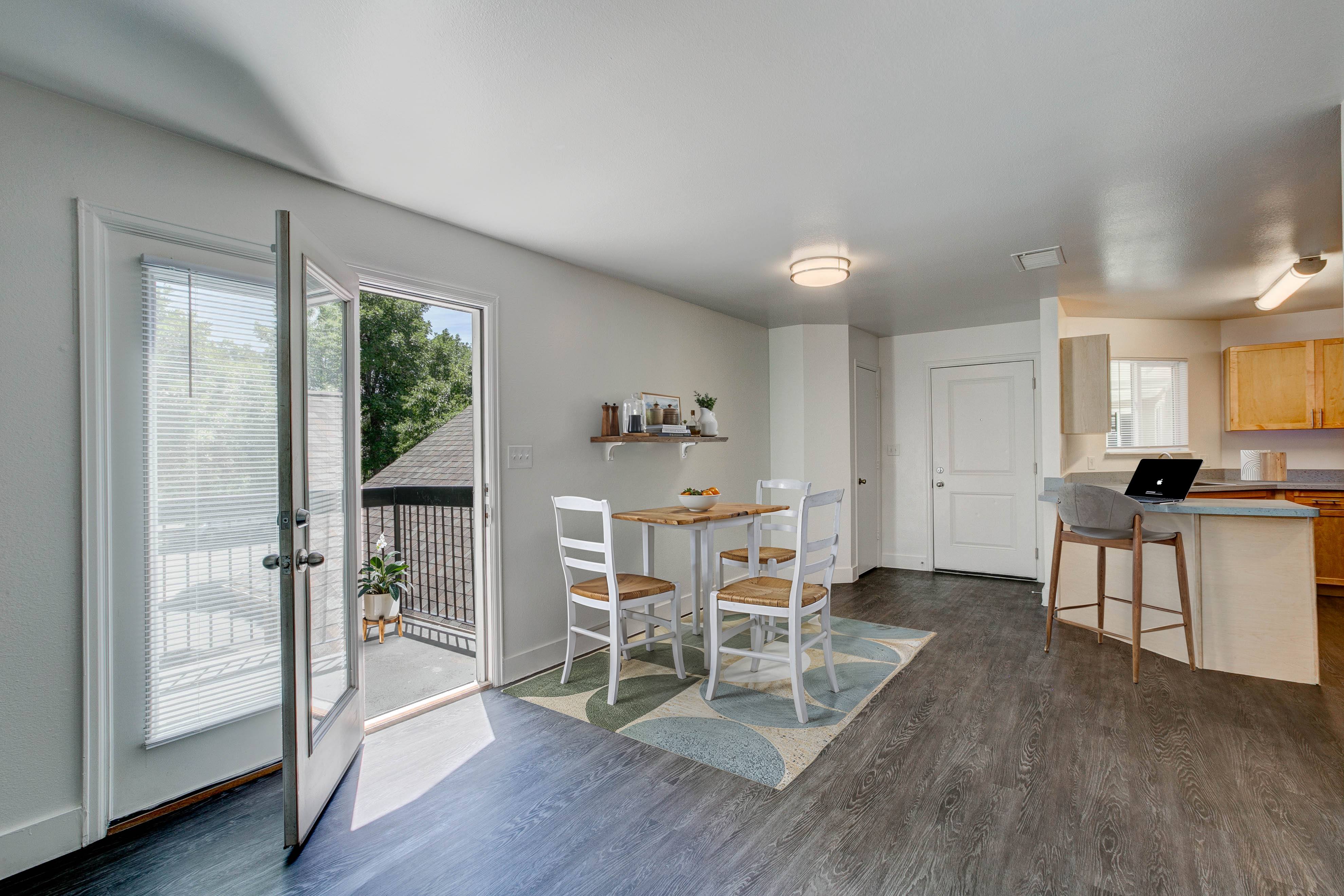 A kitchen with a table and chairs is shown in the image.