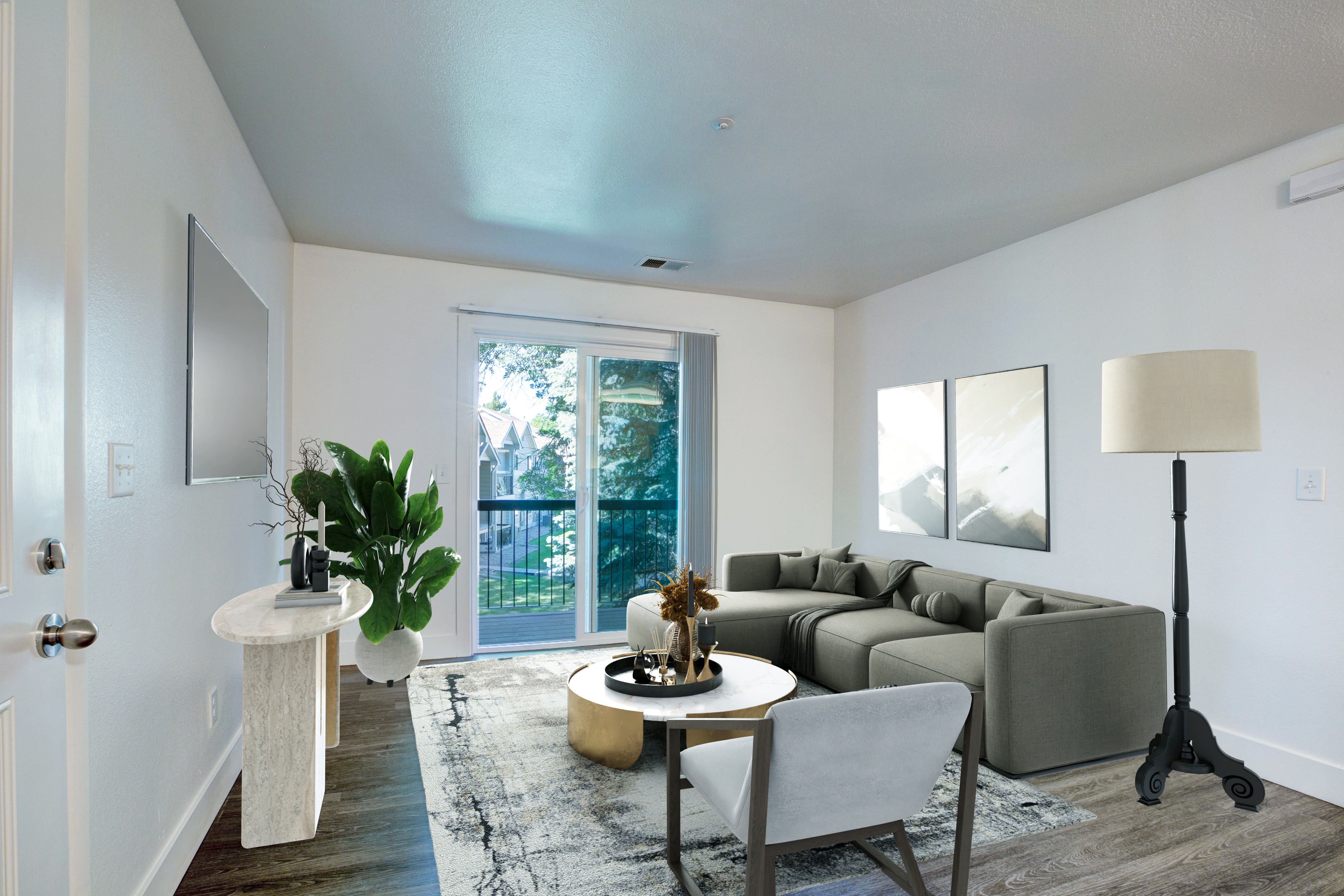 A living room with a grey couch and a white table.