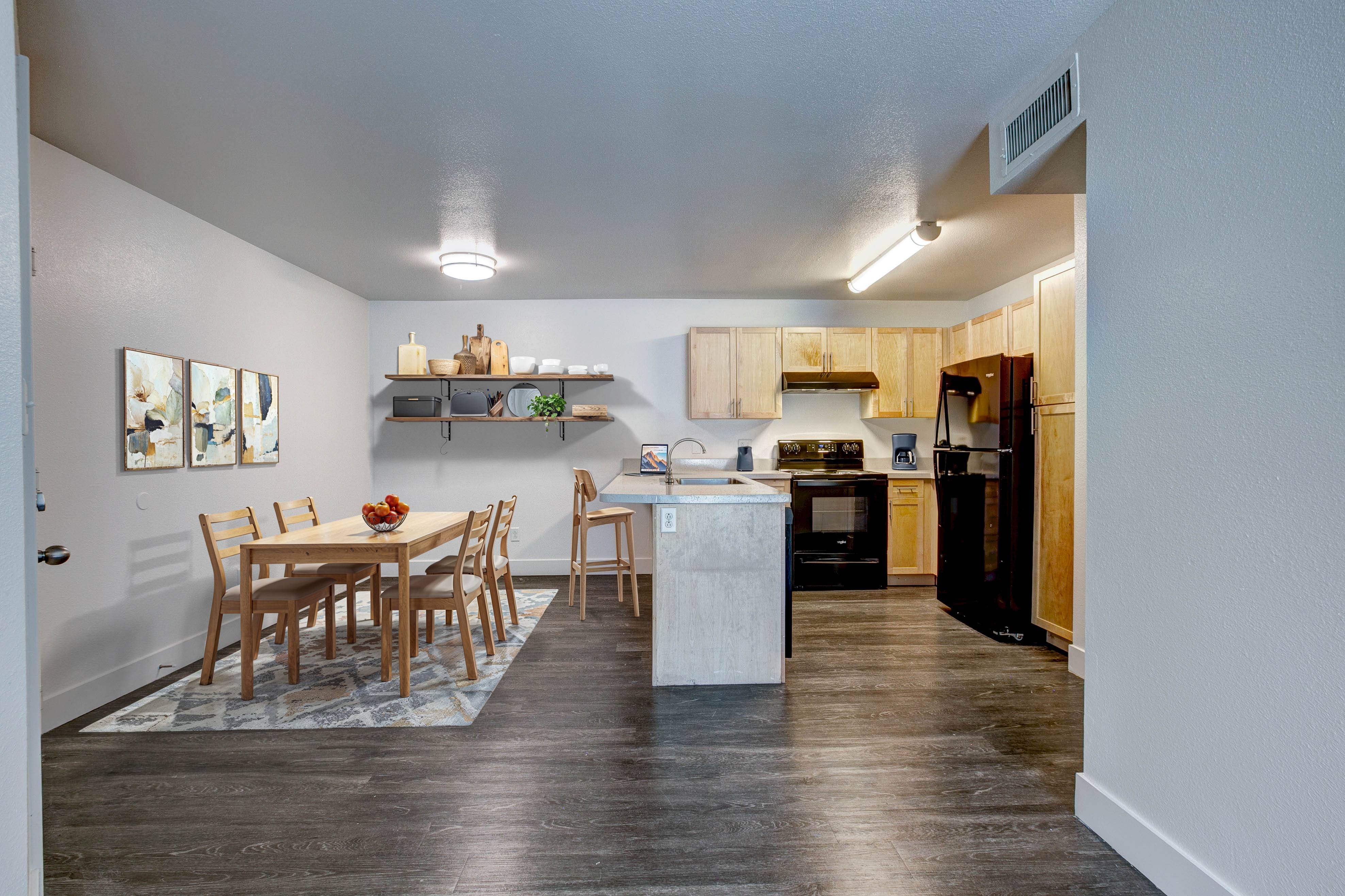 A kitchen with a dining table and chairs.,A kitchen with a dining table and chairs.