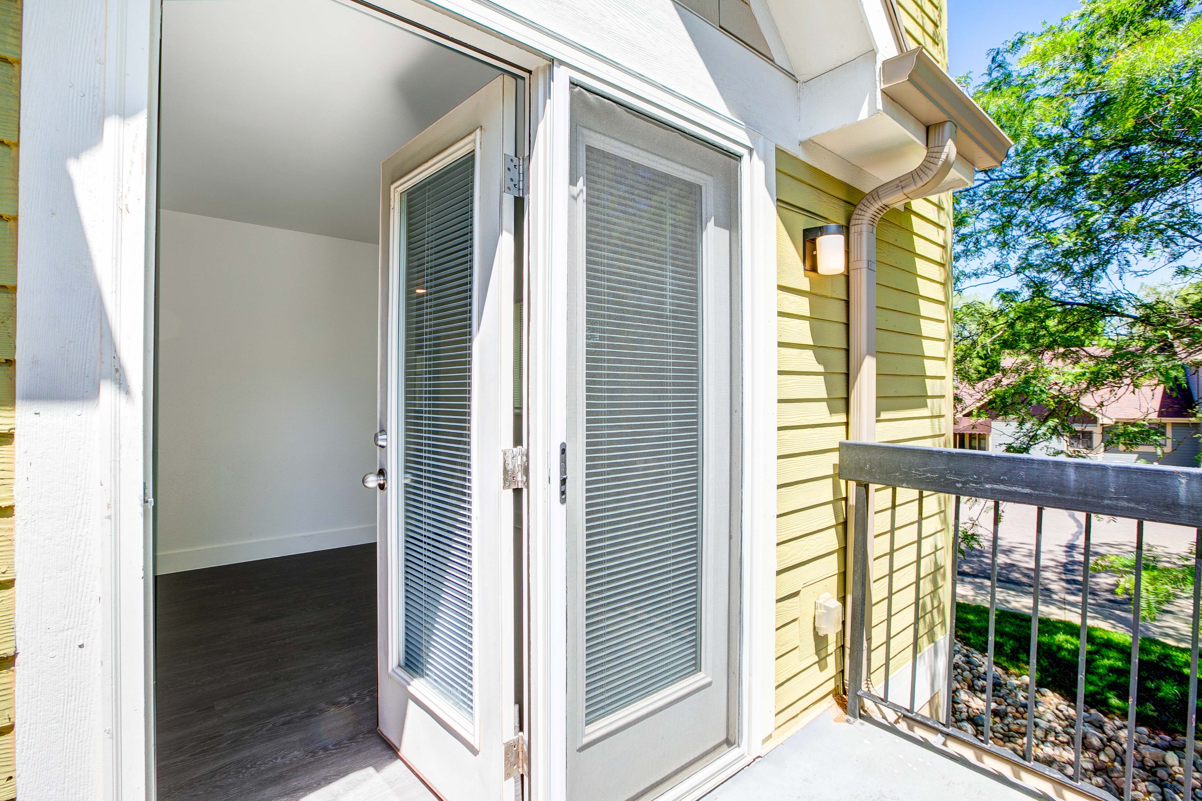 A white door with a glass window is open.