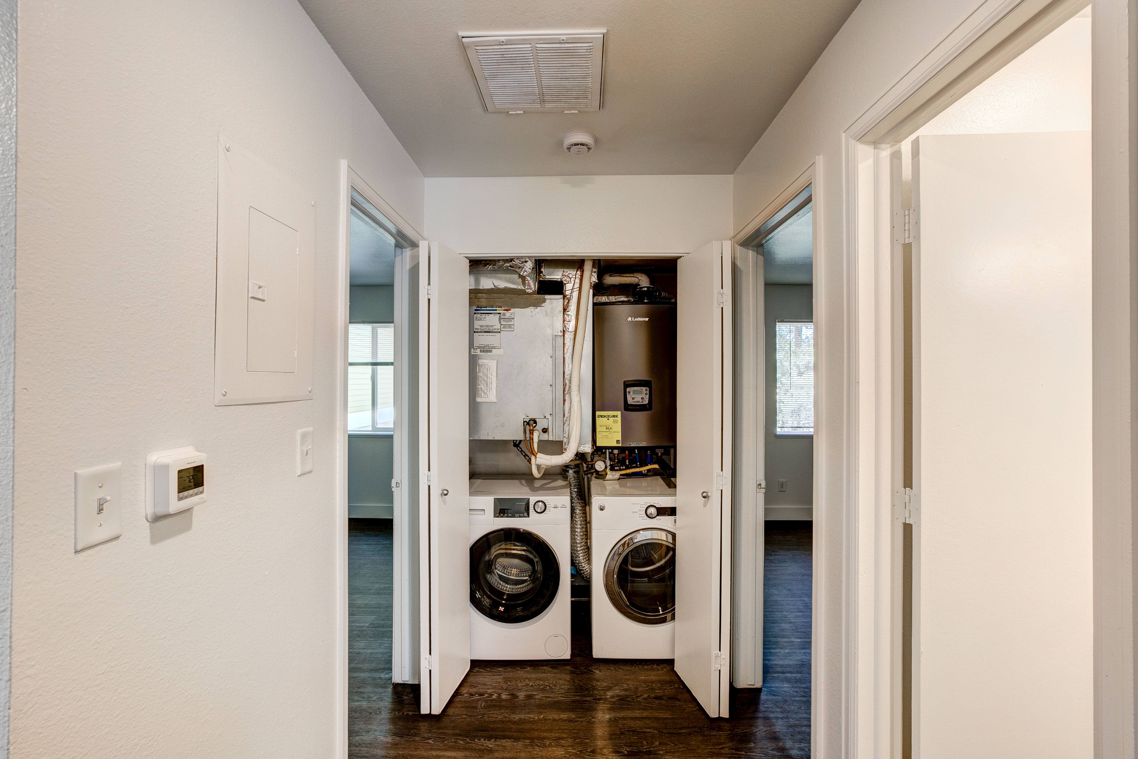 A laundry room with a washer and dryer in it.