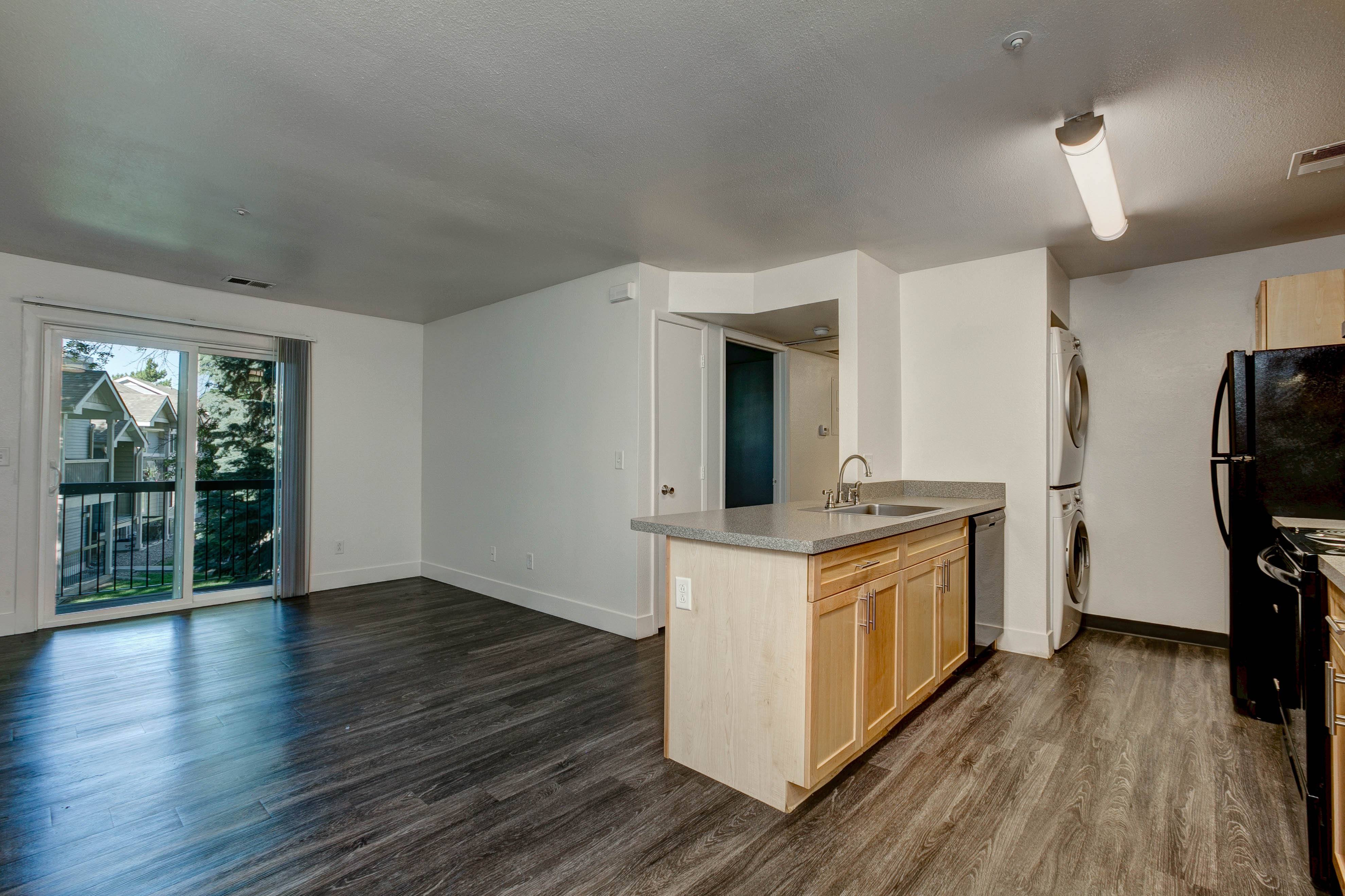A kitchen area with a sink and a refrigerator.