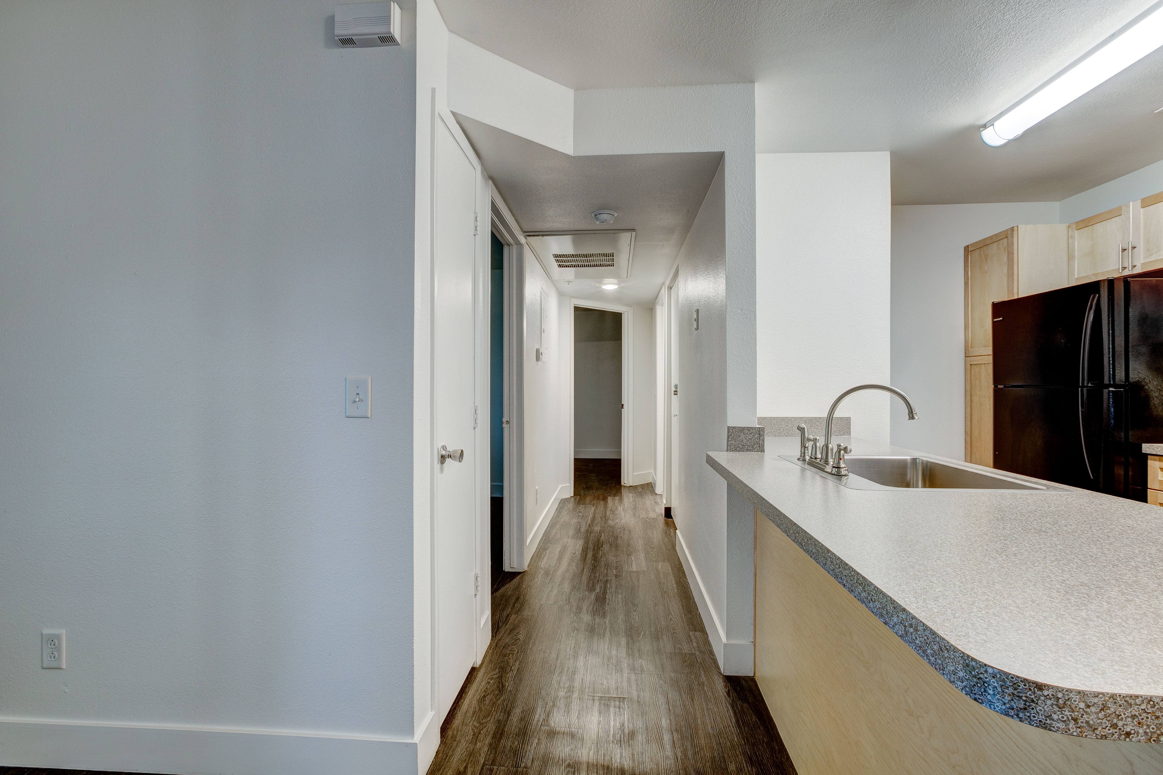 A kitchen with a sink and a counter.