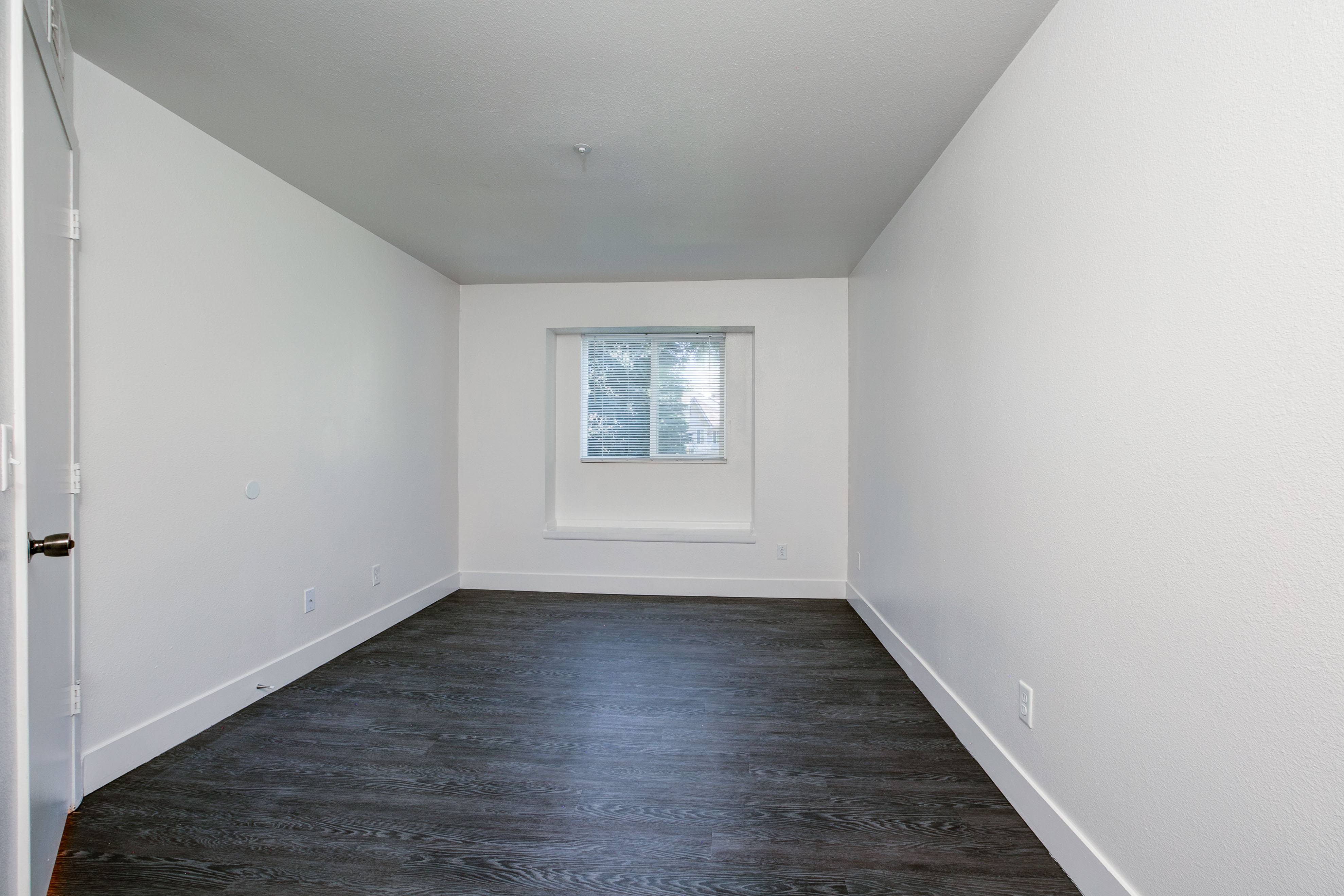 A room with a window and a door.