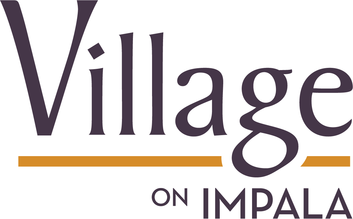 A green sign with the words "Village on Impala" written in purple.