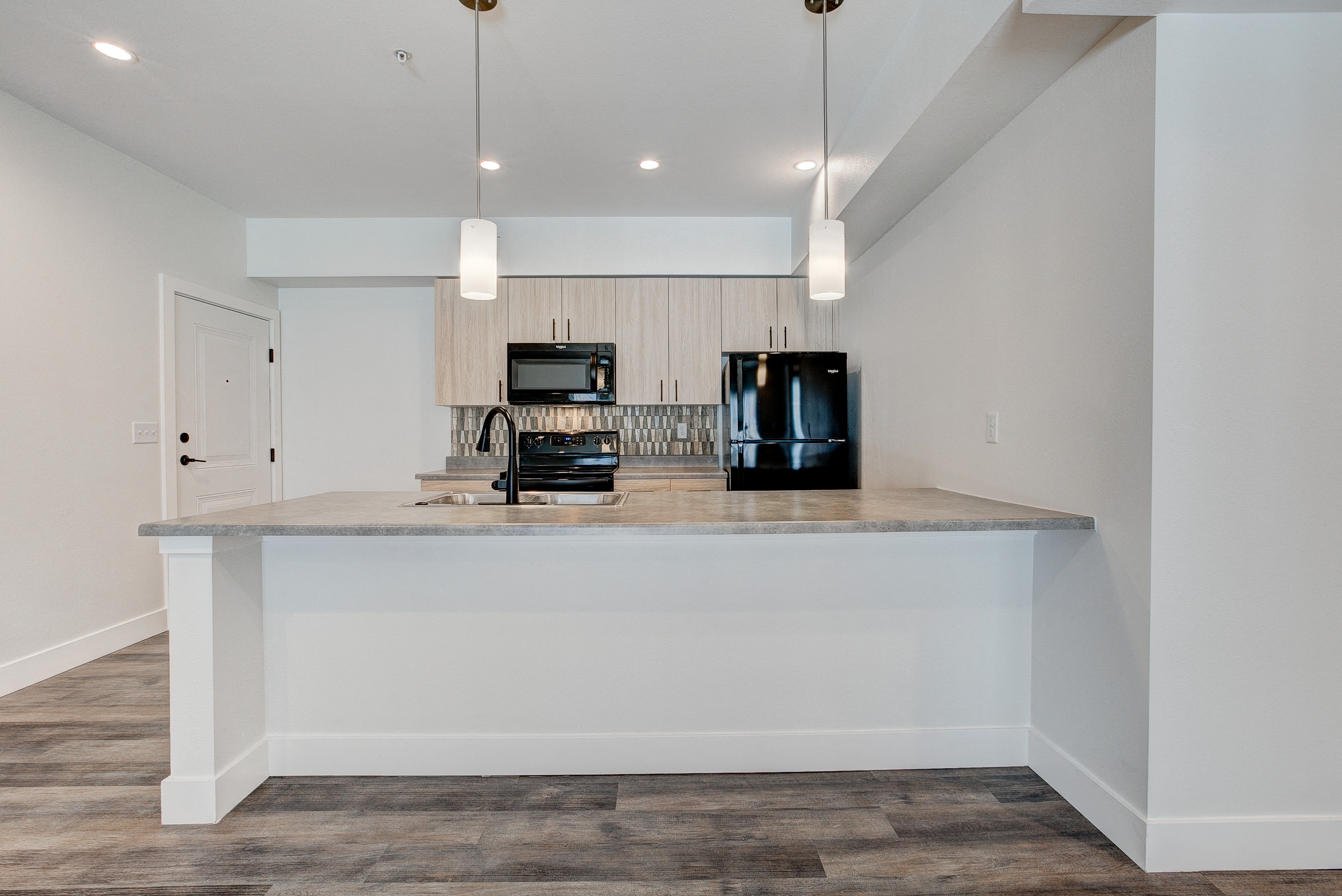 A kitchen island with a microwave and a coffee maker on it.