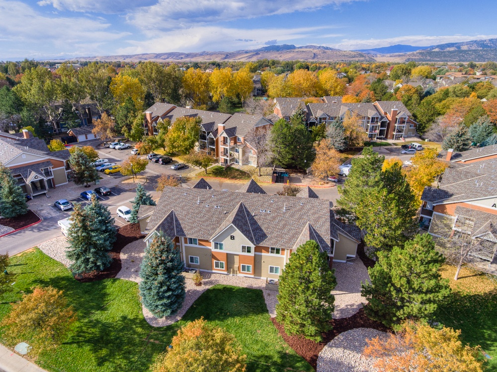 A bird's eye view of a residential area with houses and trees.