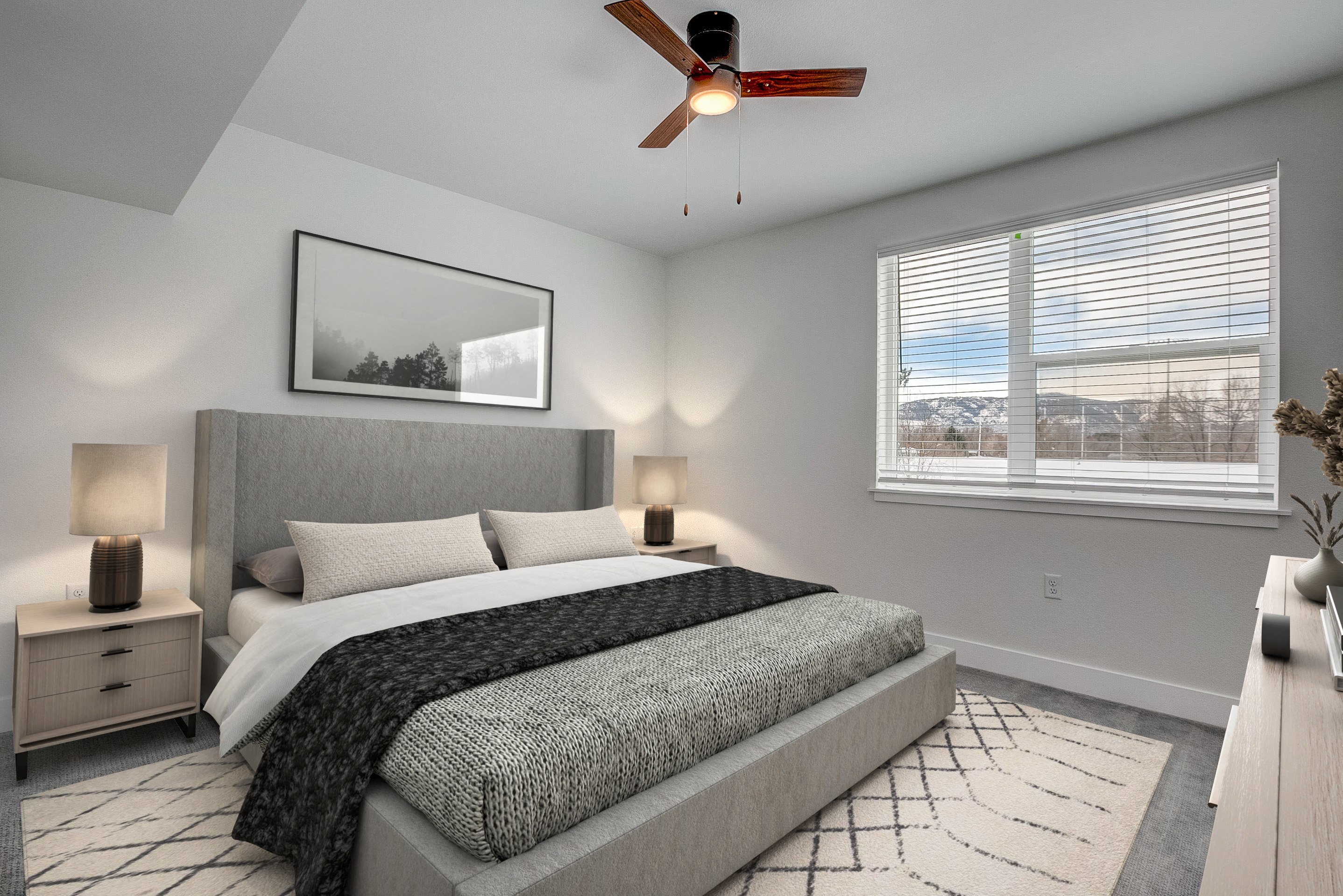 A bedroom with a large bed and a ceiling fan.