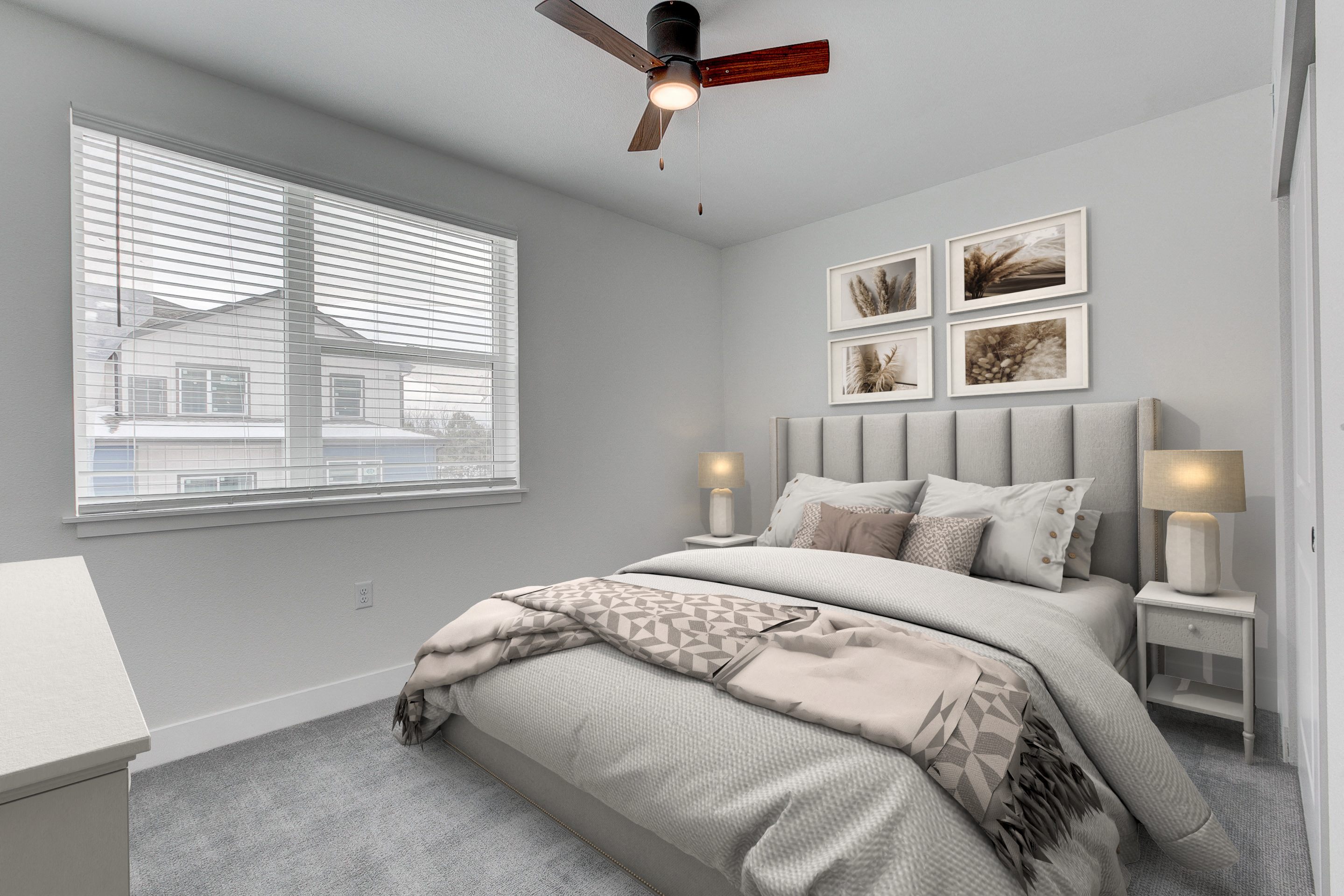 A bedroom with a large bed and a ceiling fan.