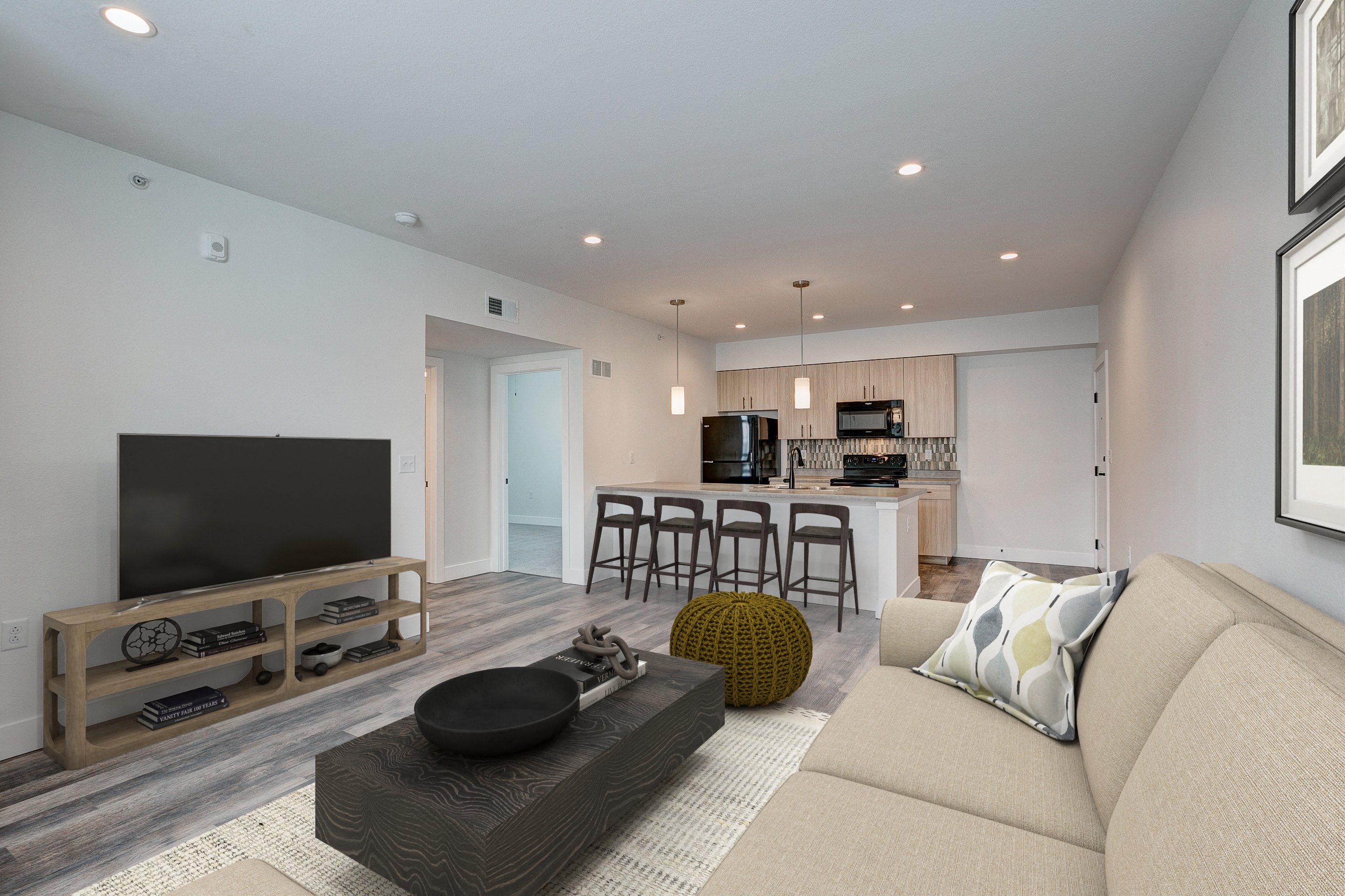 A modern living room with a flat screen TV and a sofa.