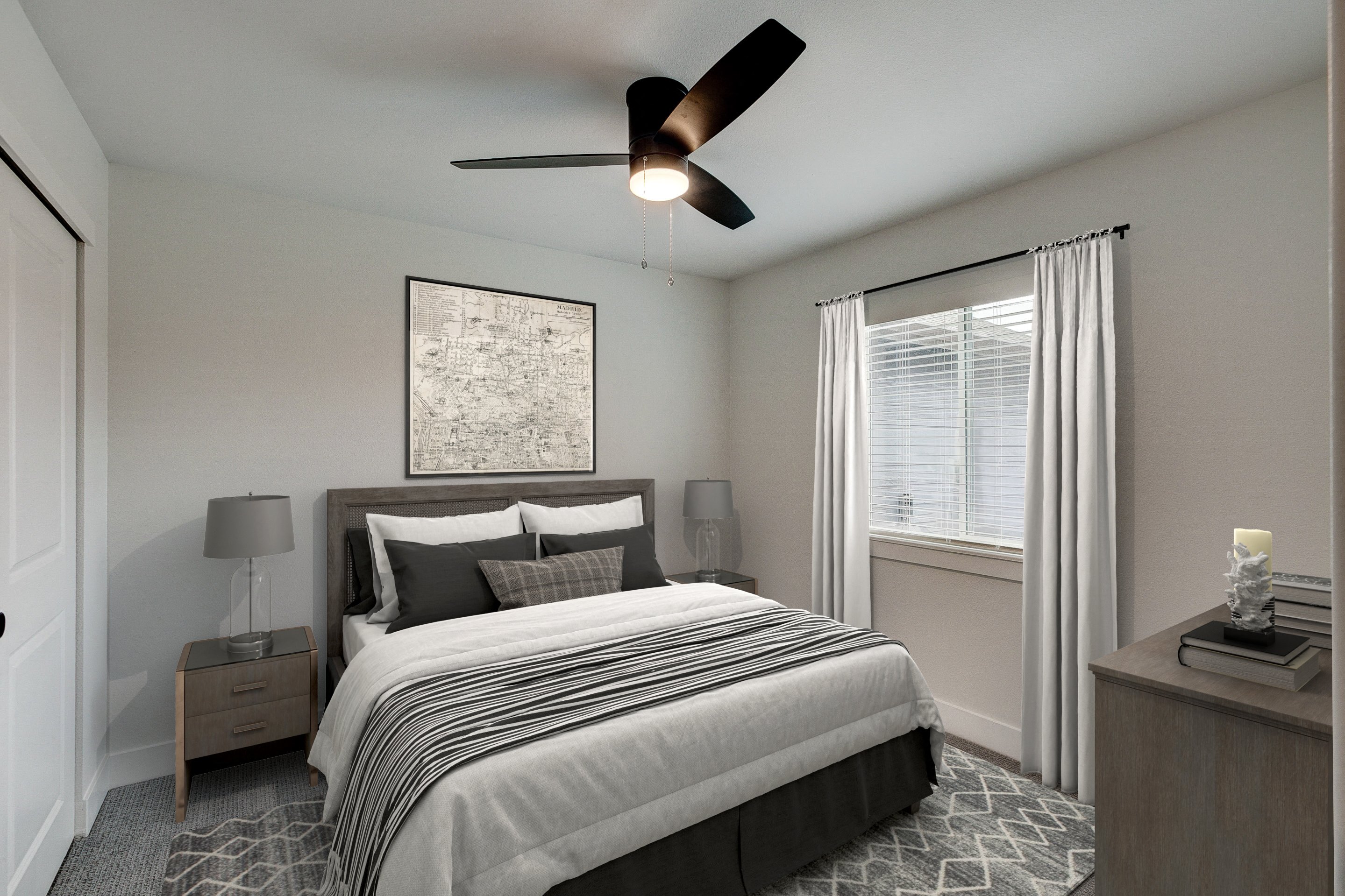 A bedroom with a large bed, a ceiling fan, and a painting on the wall.