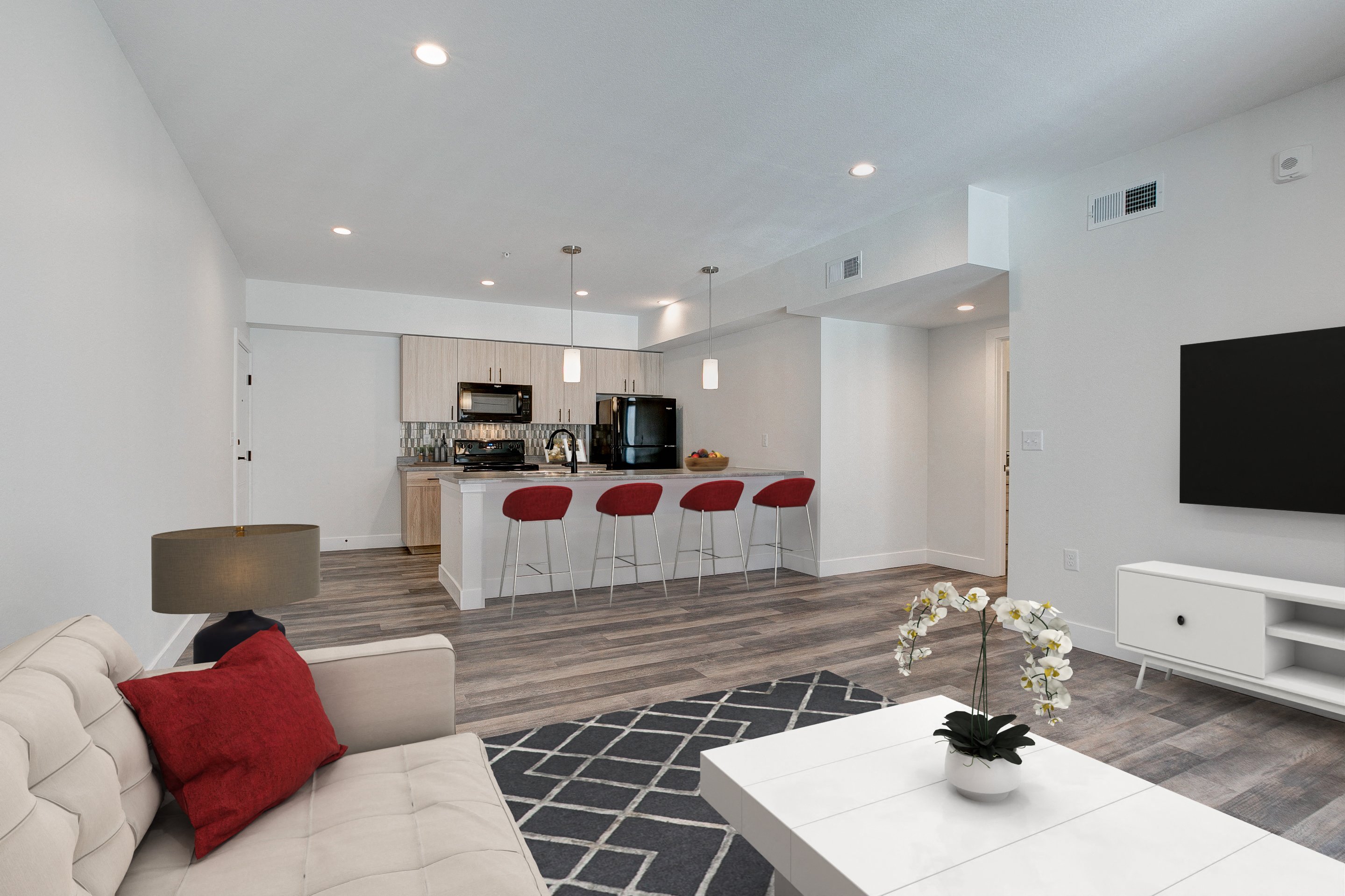 A modern living room with a white sofa and a black television.