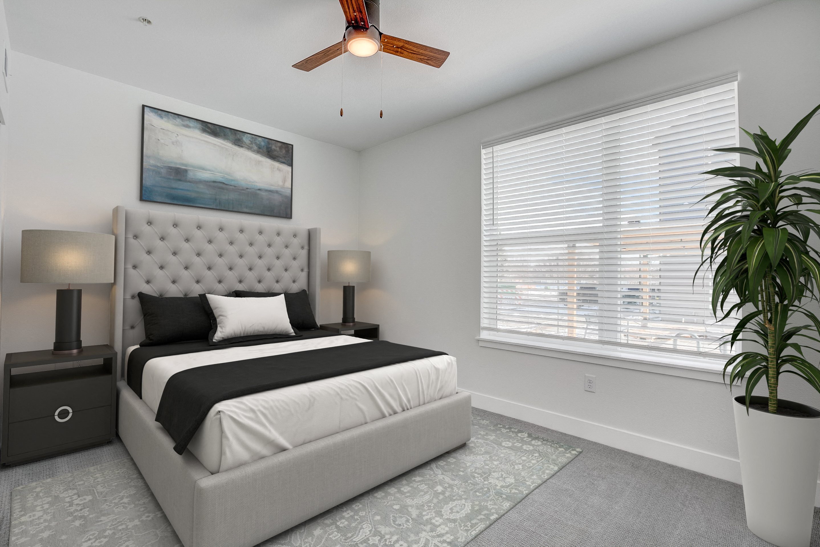 A bedroom with a large bed and a ceiling fan.