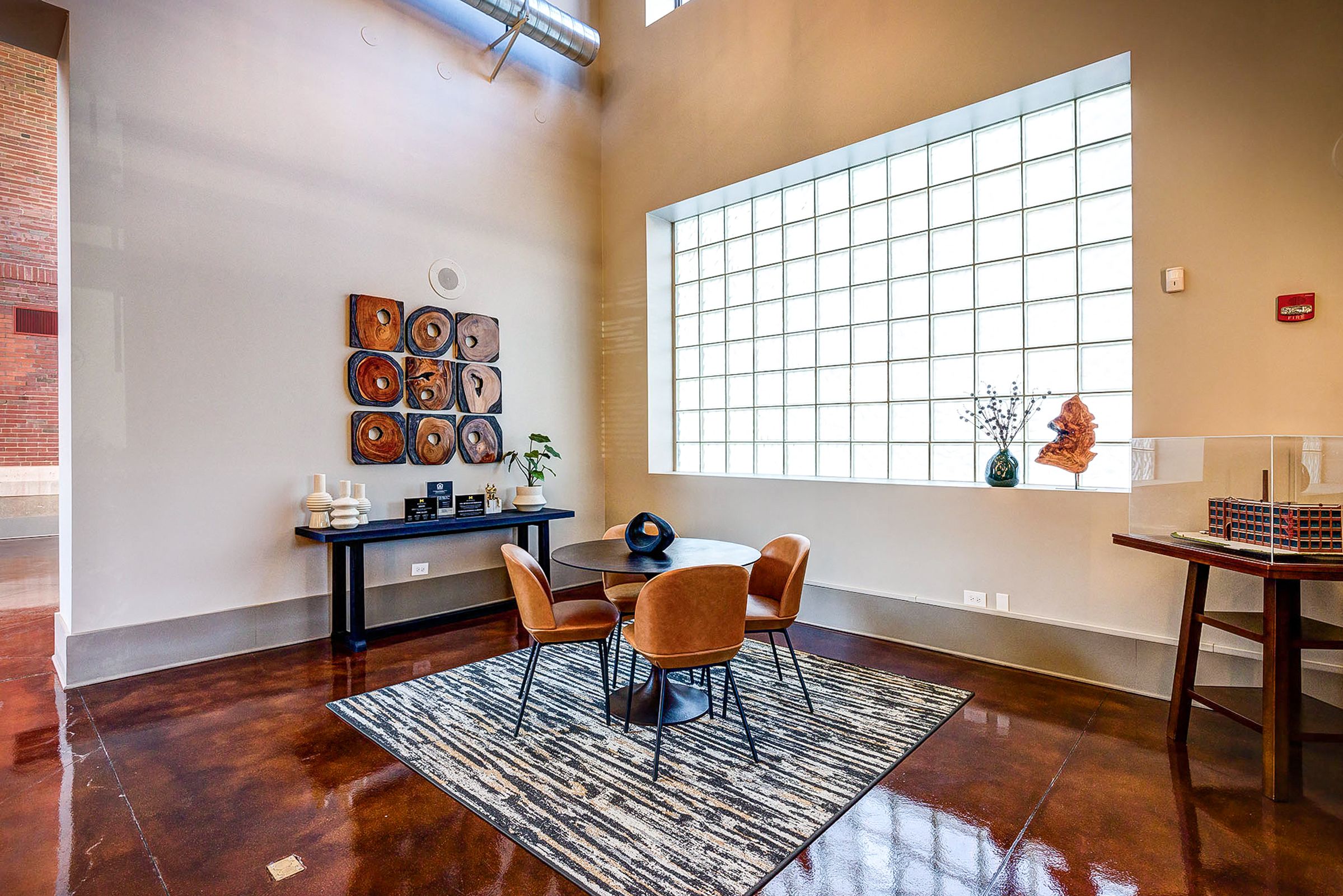 dining table on a rug in front of a large window