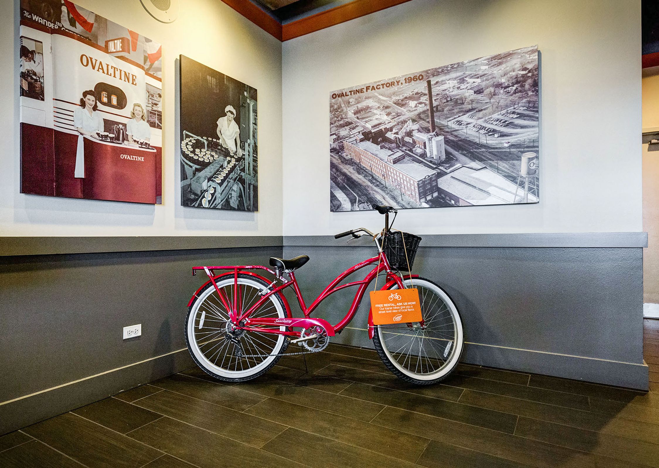 red bike in front of a wall