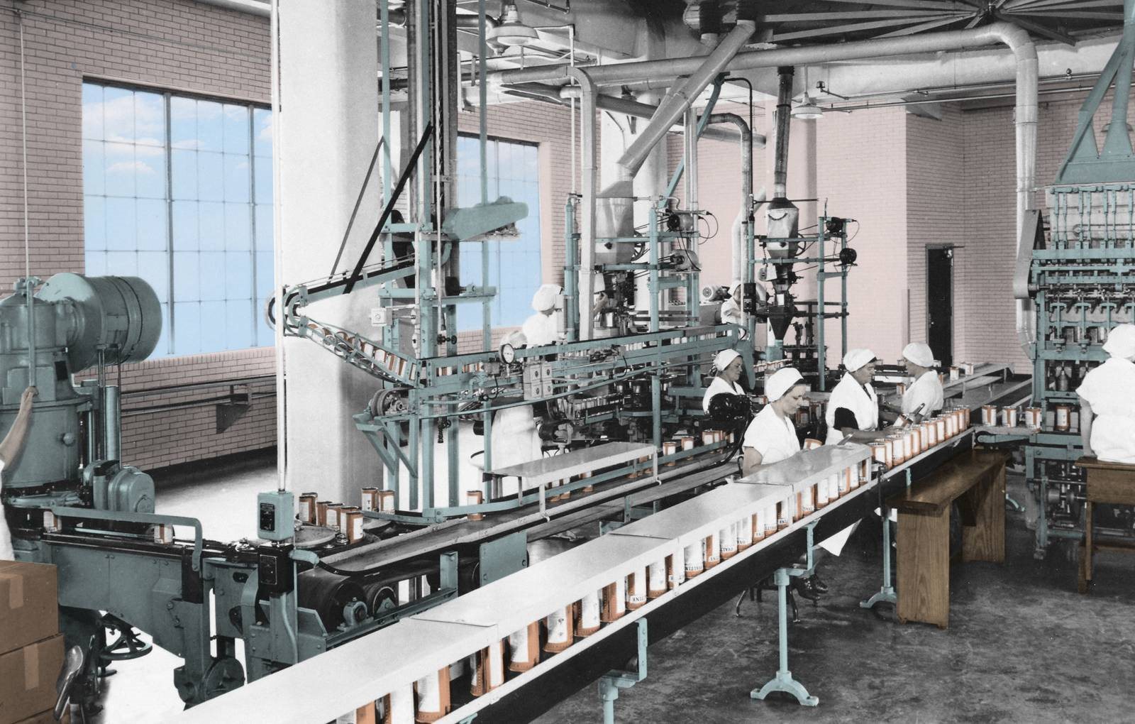 a group of people working on a machine in a factory