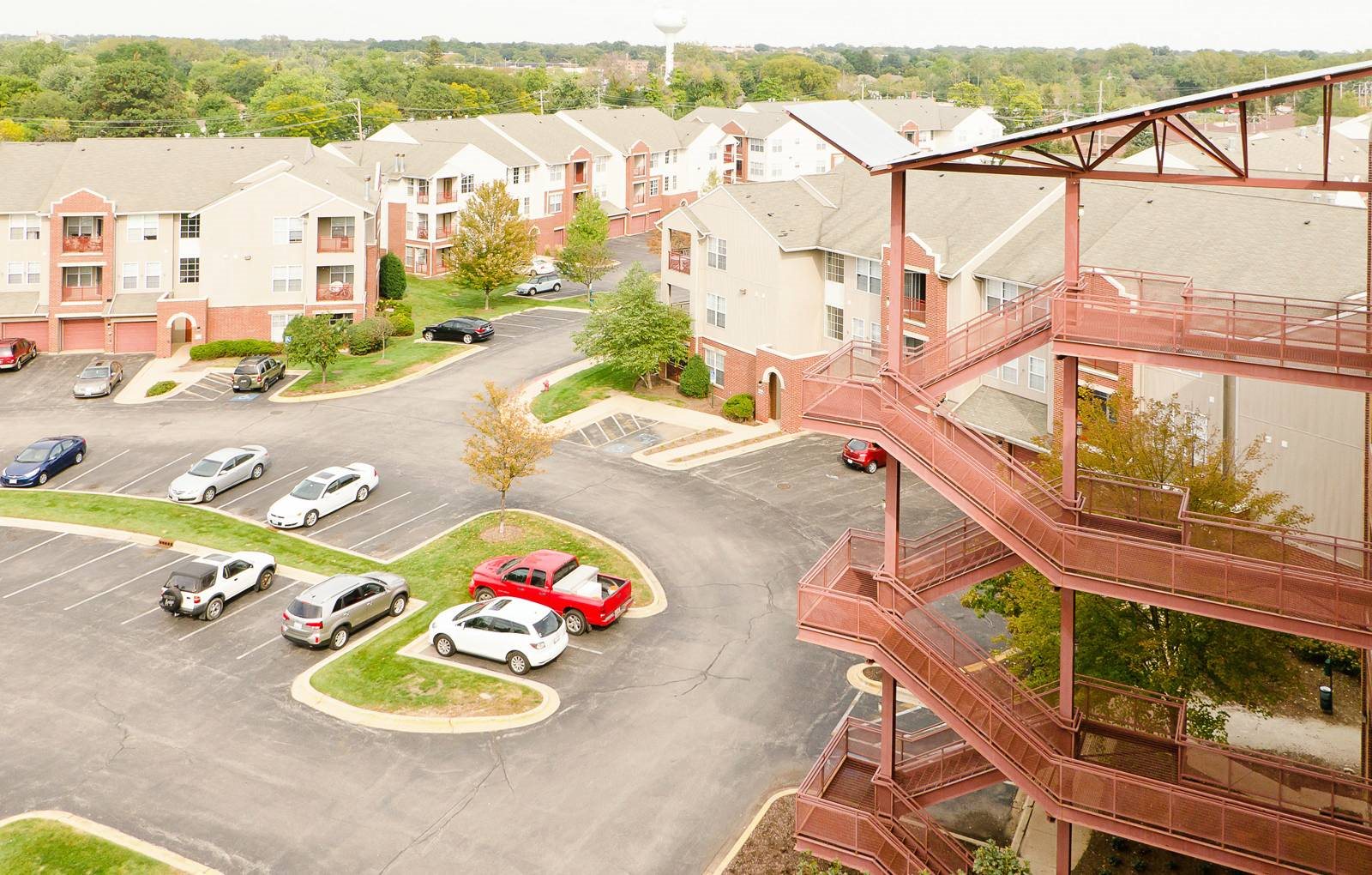 A spacious apartment building parking lot for residents.