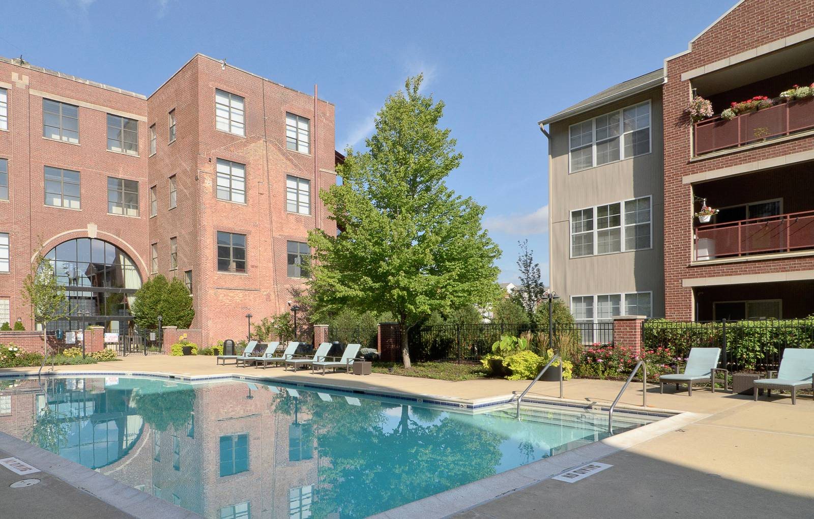 A resort-style pool in front of a modern apartment building.