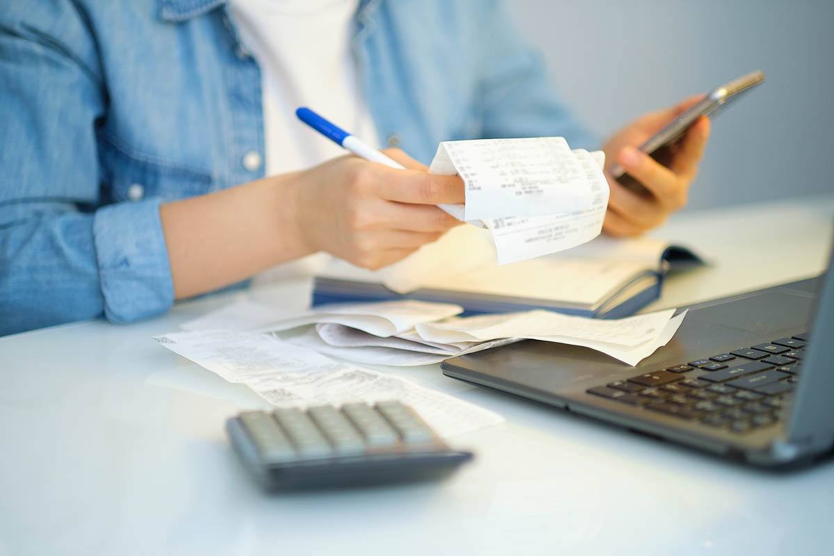 A person is looking at bills while living in an apartment