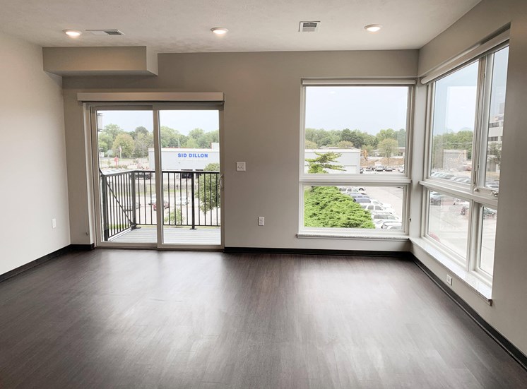 Living room view through corner floor to ceiling windows and sliding door that look out onto north Lincoln, Nebraska