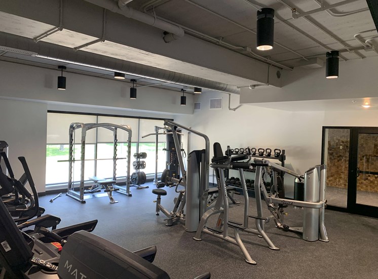 Fitness center with strength training and cardio equipment at Haven at Uptown