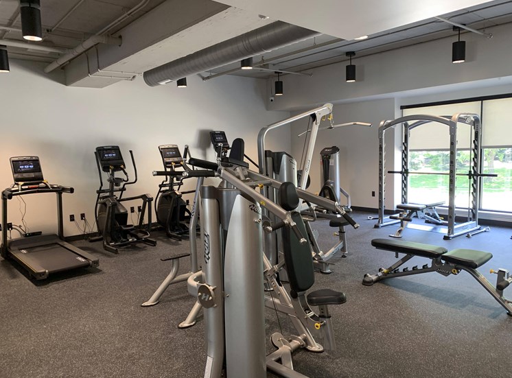 Fitness center with strength training and cardio equipment at Haven at Uptown