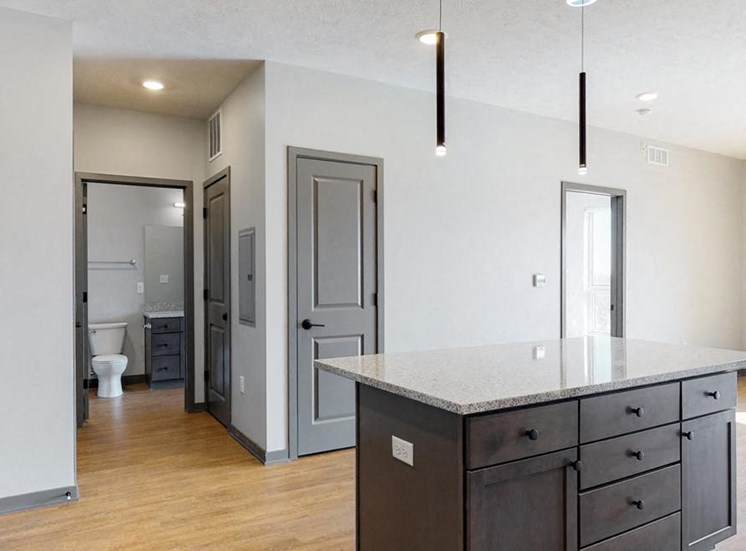 View of kitchen island and hallway leading to the bathroom in the Bliss floor plan at Haven at Uptown in Lincoln, NE