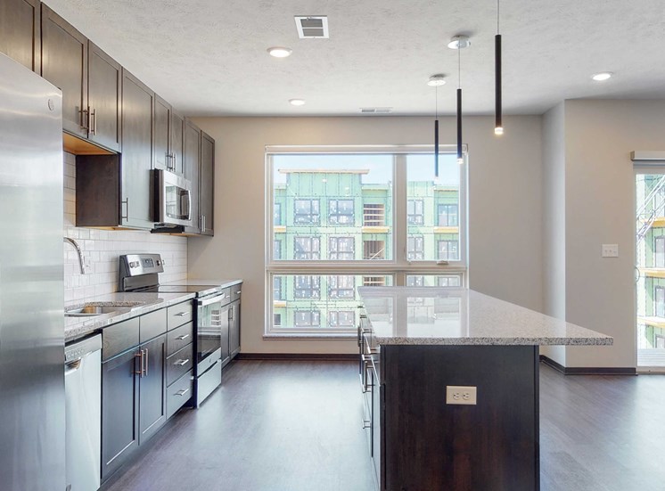Spacious kitchen with mocha finishes in the Melody floor plan at Haven at Uptown in Lincoln, NE