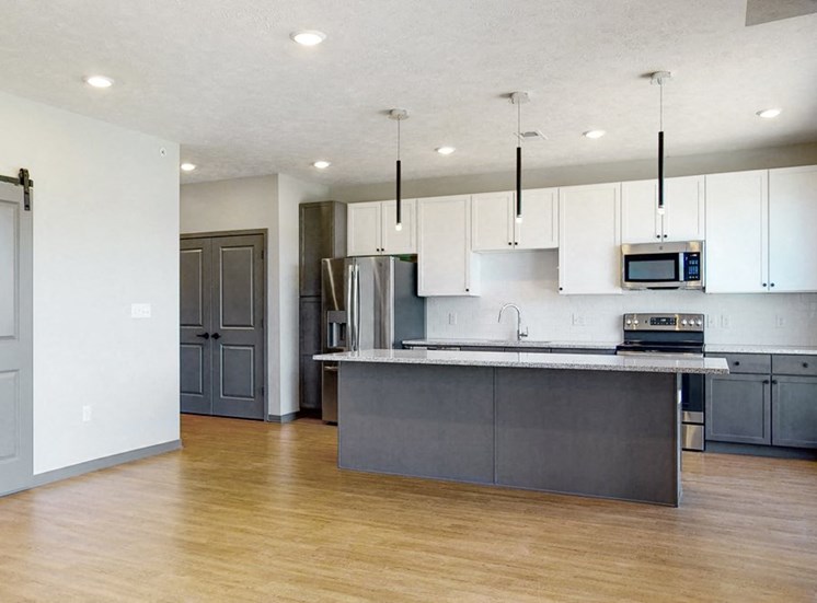 Kitchen island provides additional seating in the Melody floor plan at Haven at Uptown in Lincoln, NE