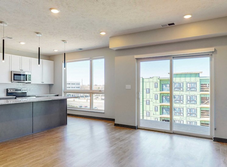 Kitchen and living space with abundant natural light in the Melody floor plan at Haven at Uptown in Lincoln, NE