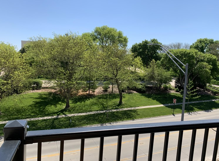 Scenic tree filled park view from outdoor balcony at Haven at Uptown in Lincoln.